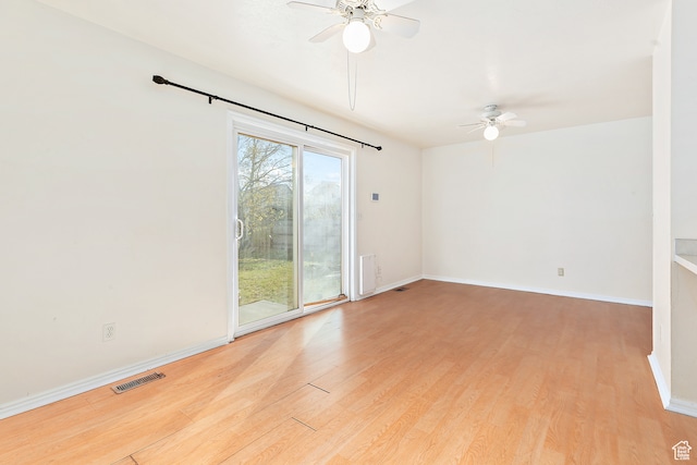 spare room with ceiling fan and light wood-type flooring