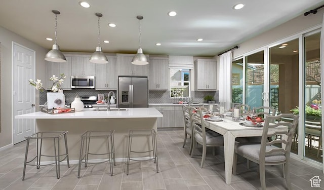 437 W Lefty Ln Unit 1118, Stansbury Park, UT 84074 - kitchen with appliances with stainless steel finishes, healthy amount of natural light, a sink, backsplash, and recessed lighting