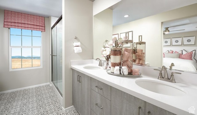 437 W Lefty Ln Unit 1118, Stansbury Park, UT 84074 - full bathroom featuring baseboards, double vanity, a shower stall, and ceiling fan