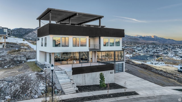 view of front facade featuring a mountain view and a balcony