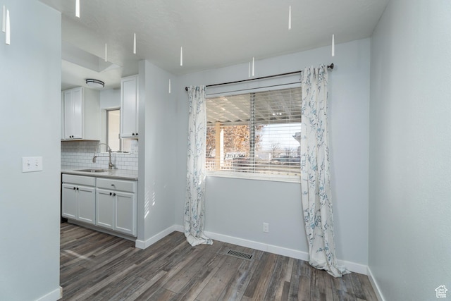 1052 N 2500 W, Vernal, UT 84078 - unfurnished dining area featuring dark wood-style floors, baseboards, and a sink