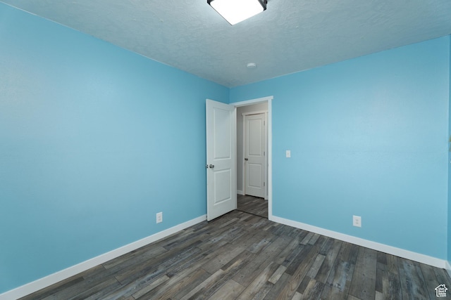 1052 N 2500 W, Vernal, UT 84078 - unfurnished room featuring baseboards, dark wood-style floors, and a textured ceiling
