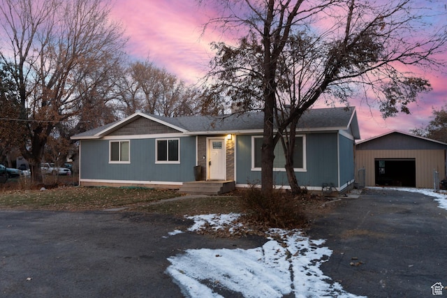 ranch-style house featuring an outbuilding and a garage