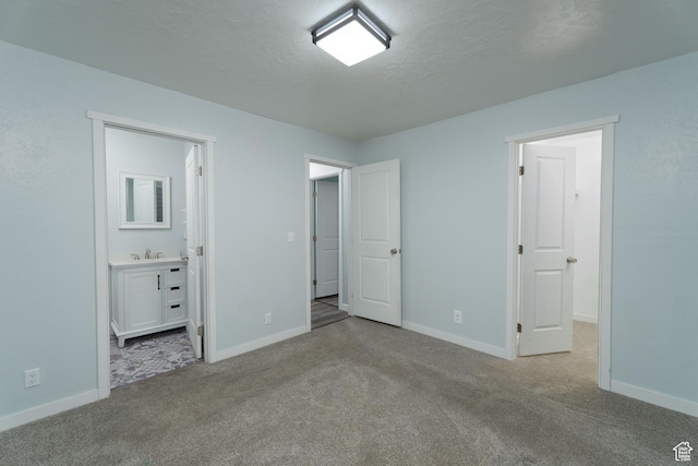 1052 N 2500 W, Vernal, UT 84078 - unfurnished bedroom with carpet, baseboards, a textured ceiling, and a sink