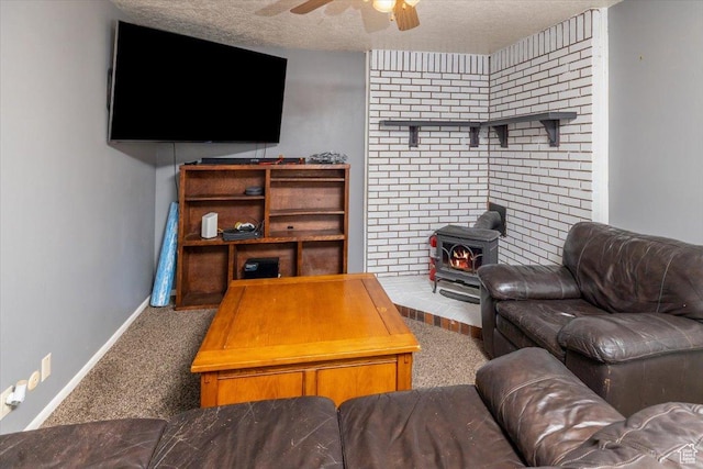 281 W 600 N Unit 4, Logan, UT 84321 - living room featuring carpet flooring, a textured ceiling, a wood stove, and ceiling fan
