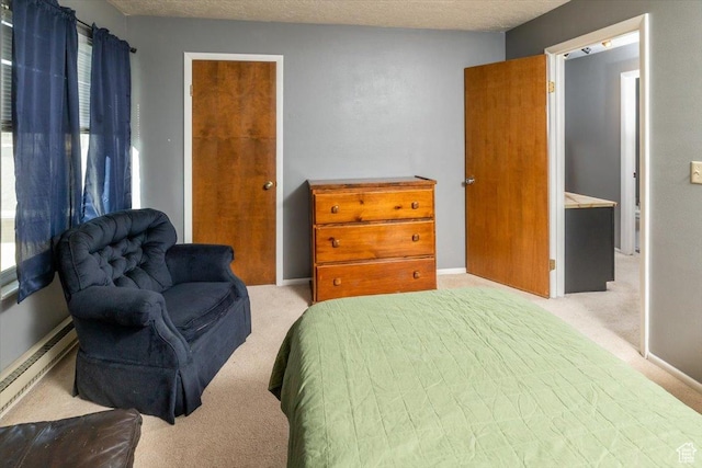 281 W 600 N Unit 4, Logan, UT 84321 - carpeted bedroom featuring a textured ceiling, ensuite bath, and baseboard heating