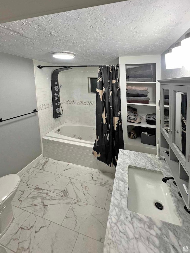 full bath featuring baseboards, toilet, a tub with jets, marble finish floor, and tiled shower