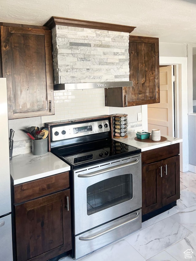 kitchen featuring stainless steel appliances, light countertops, marble finish floor, and dark brown cabinetry