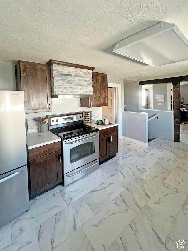 kitchen with dark brown cabinets, appliances with stainless steel finishes, light countertops, and marble finish floor