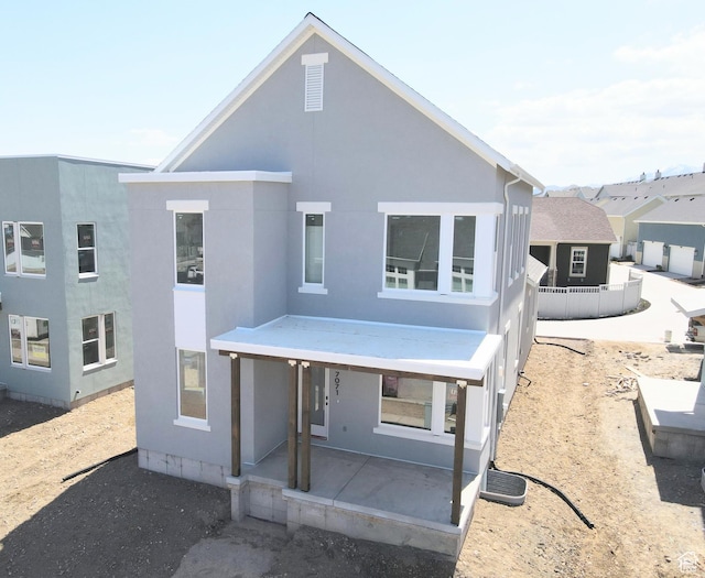 view of front facade with a patio area and stucco siding