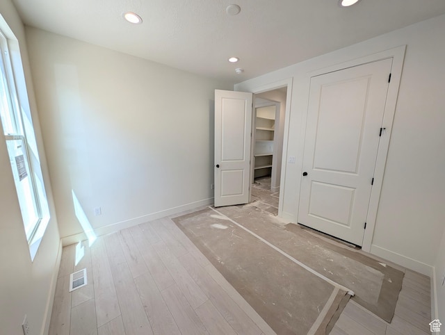 unfurnished bedroom with visible vents, recessed lighting, baseboards, and light wood-style flooring