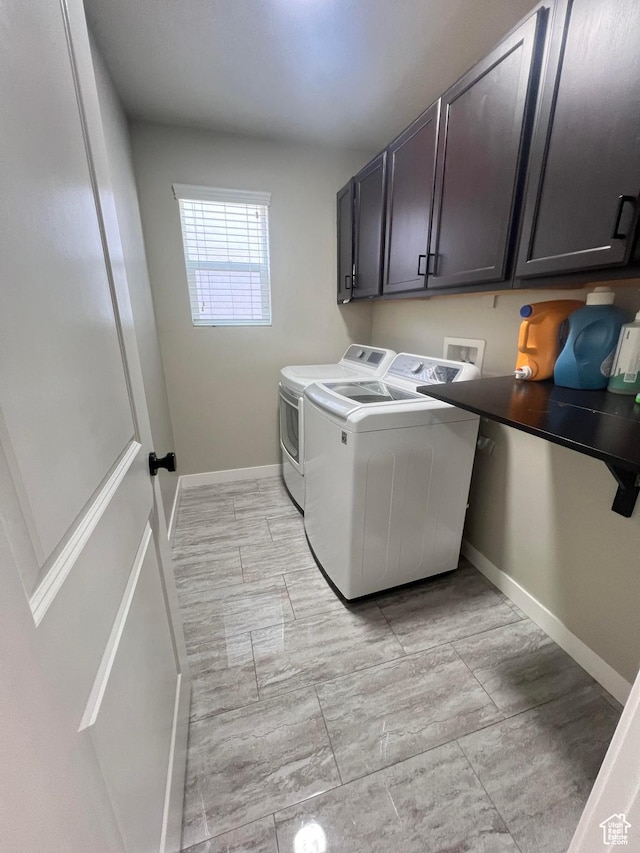 washroom with cabinets and washing machine and clothes dryer