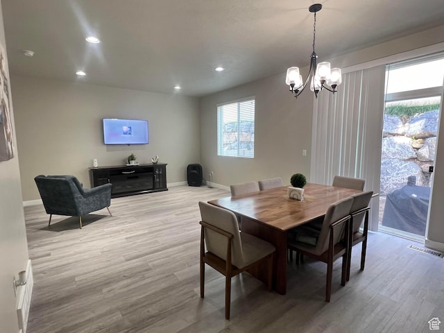 dining room featuring light hardwood / wood-style floors and an inviting chandelier