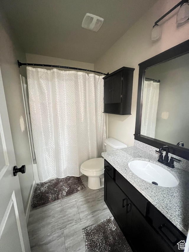 full bathroom with vanity, toilet, and shower / bath combo with shower curtain