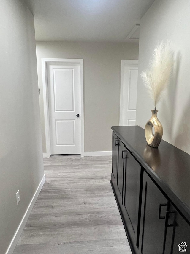 corridor with light hardwood / wood-style flooring