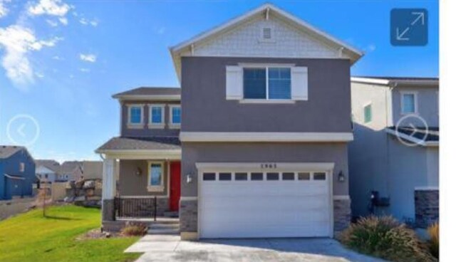 view of front of home featuring a front yard and a garage