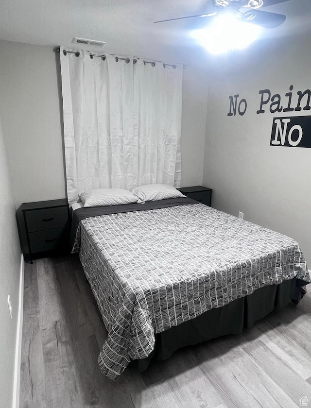 bedroom featuring wood-type flooring and ceiling fan