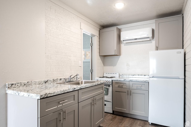 1180 S Cove View Rd, Richfield, UT 84701 - kitchen featuring sink, range with gas cooktop, dark hardwood / wood-style floors, white refrigerator, and a wall unit AC