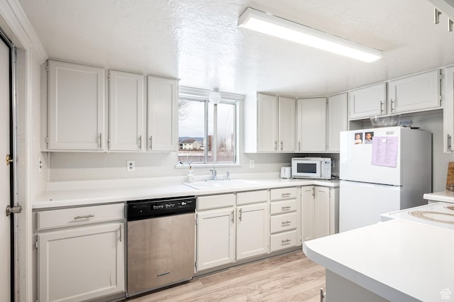 1180 S Cove View Rd, Richfield, UT 84701 - kitchen with sink, light hardwood / wood-style floors, a textured ceiling, white appliances, and white cabinets