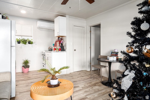 1180 S Cove View Rd, Richfield, UT 84701 - kitchen featuring white refrigerator, an AC wall unit, light hardwood / wood-style floors, white cabinets, and ornamental molding