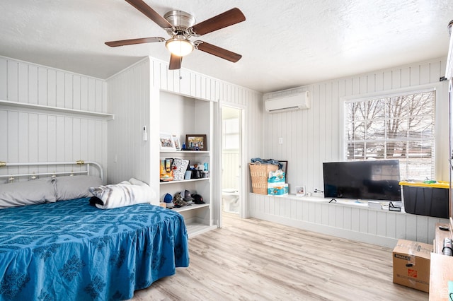 1180 S Cove View Rd, Richfield, UT 84701 - bedroom with ceiling fan, an AC wall unit, a textured ceiling, and light hardwood / wood-style flooring