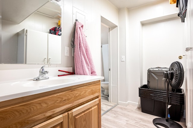 1180 S Cove View Rd, Richfield, UT 84701 - bathroom with toilet, vanity, ornamental molding, and hardwood / wood-style flooring