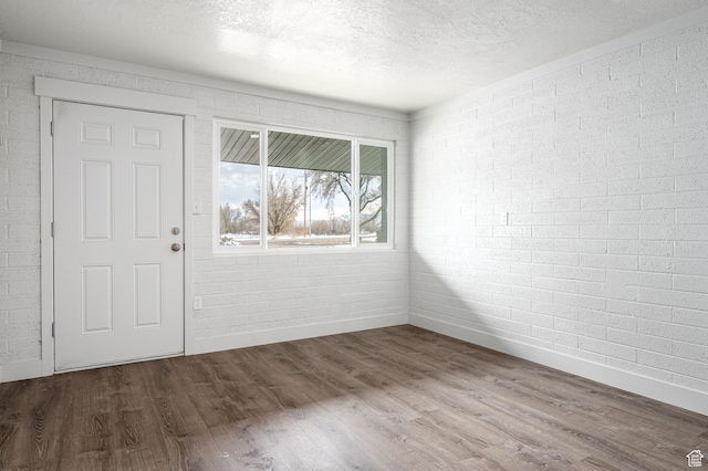 1180 S Cove View Rd, Richfield, UT 84701 - foyer featuring wood-type flooring, a textured ceiling, and brick wall