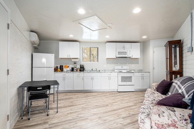 1180 S Cove View Rd, Richfield, UT 84701 - kitchen with sink, a wall unit AC, white appliances, white cabinets, and light wood-type flooring