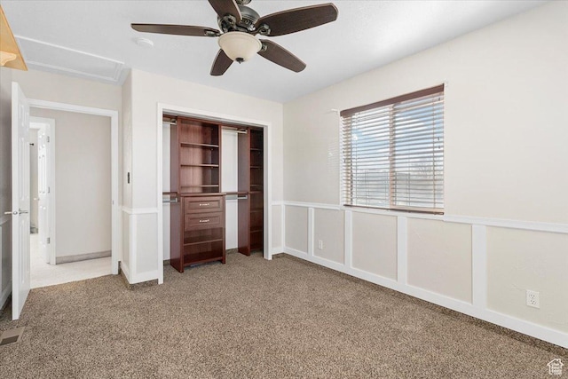 unfurnished bedroom featuring ceiling fan, carpet floors, and a closet