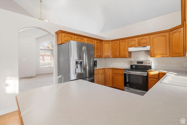 kitchen with stainless steel appliances, vaulted ceiling, and sink