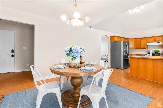 68 E 100 N, Nephi, UT 84648 - dining space featuring light wood-style floors, a chandelier, baseboards, and arched walkways