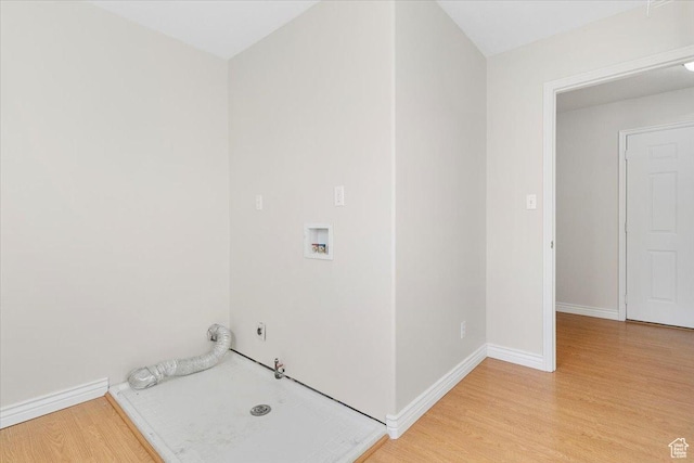 laundry area with hookup for a washing machine, light hardwood / wood-style flooring, and hookup for a gas dryer