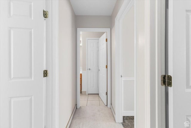 hallway featuring light colored carpet