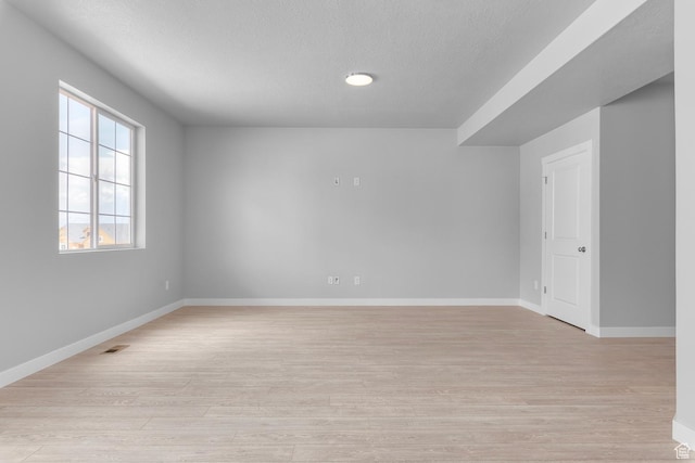 6636 W Prairie Fire Ln Unit 733, Herriman, UT 84096 - spare room with a textured ceiling and light hardwood / wood-style flooring