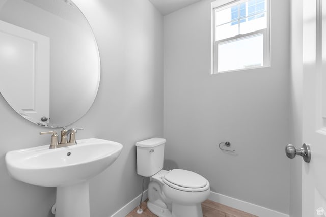 6636 W Prairie Fire Ln Unit 733, Herriman, UT 84096 - bathroom featuring hardwood / wood-style floors, toilet, and sink