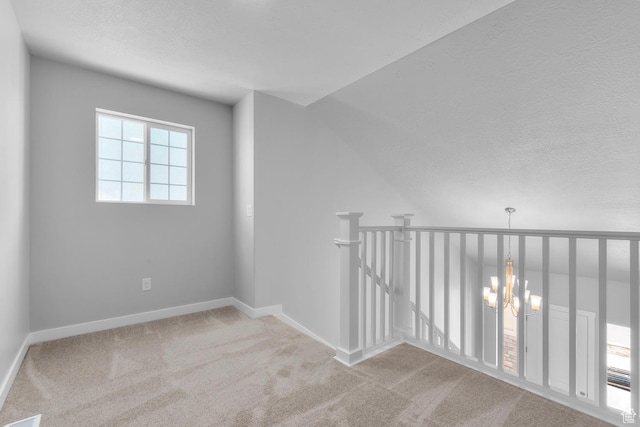 6636 W Prairie Fire Ln Unit 733, Herriman, UT 84096 - spare room featuring a chandelier, light carpet, and a textured ceiling