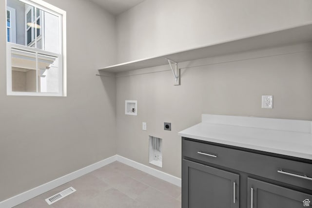 clothes washing area with cabinets, washer hookup, and electric dryer hookup