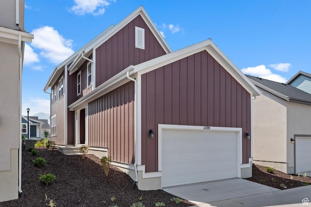 view of property exterior featuring a garage and central air condition unit