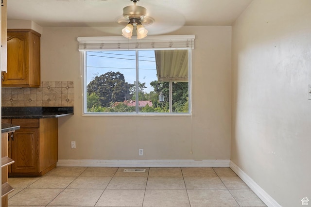 173 W 850 S, Orem, UT 84058 - unfurnished dining area featuring ceiling fan, light tile patterned flooring, and baseboards