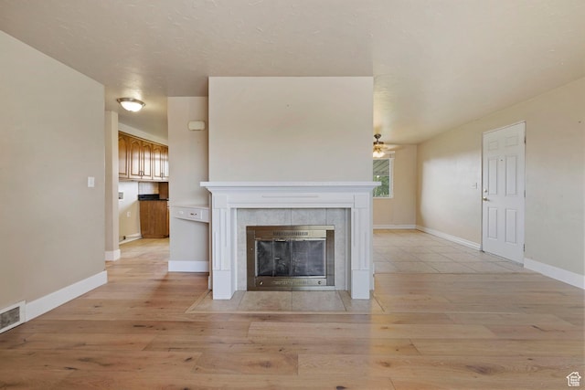 173 W 850 S, Orem, UT 84058 - unfurnished living room featuring light wood finished floors, a fireplace, a ceiling fan, and baseboards