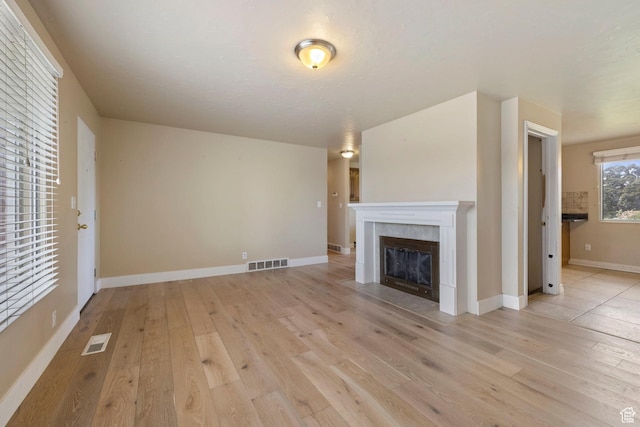 173 W 850 S, Orem, UT 84058 - unfurnished living room featuring light wood-style flooring, a fireplace, and baseboards