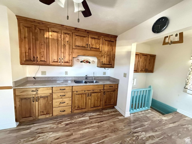 kitchen with ceiling fan, dark wood-type flooring, and sink