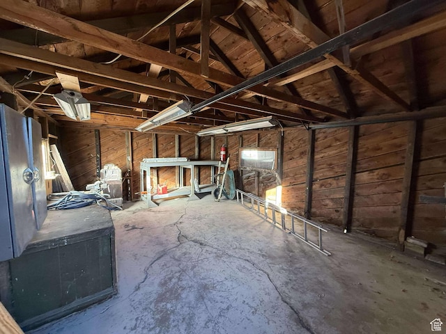 misc room featuring concrete floors and vaulted ceiling