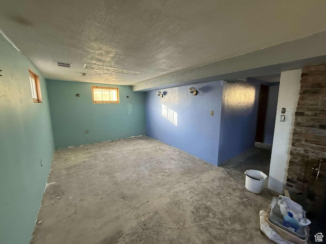 spare room with a textured ceiling