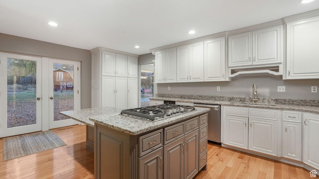 120 N 1400 E, Pleasant Grove, UT 84062 - kitchen featuring french doors, appliances with stainless steel finishes, sink, light hardwood / wood-style floors, and white cabinetry