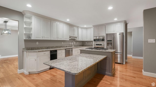 120 N 1400 E, Pleasant Grove, UT 84062 - kitchen with appliances with stainless steel finishes, a center island, light hardwood / wood-style flooring, and white cabinetry