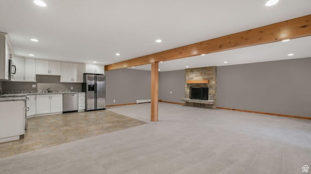 120 N 1400 E, Pleasant Grove, UT 84062 - kitchen with white cabinets, light colored carpet, a fireplace, and appliances with stainless steel finishes