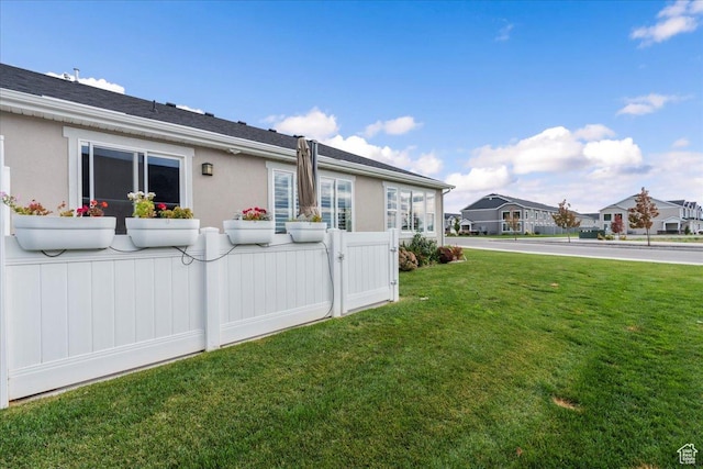 view of side of property featuring a yard