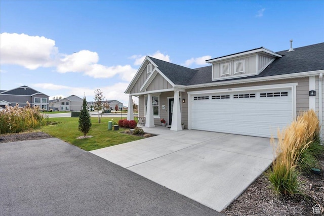 view of front of property featuring a front yard and a garage