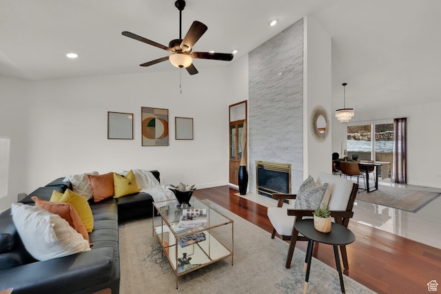 4821 S Fortuna Way, Salt Lake City, UT 84124 - living room with high vaulted ceiling, a fireplace, ceiling fan, wood finished floors, and recessed lighting